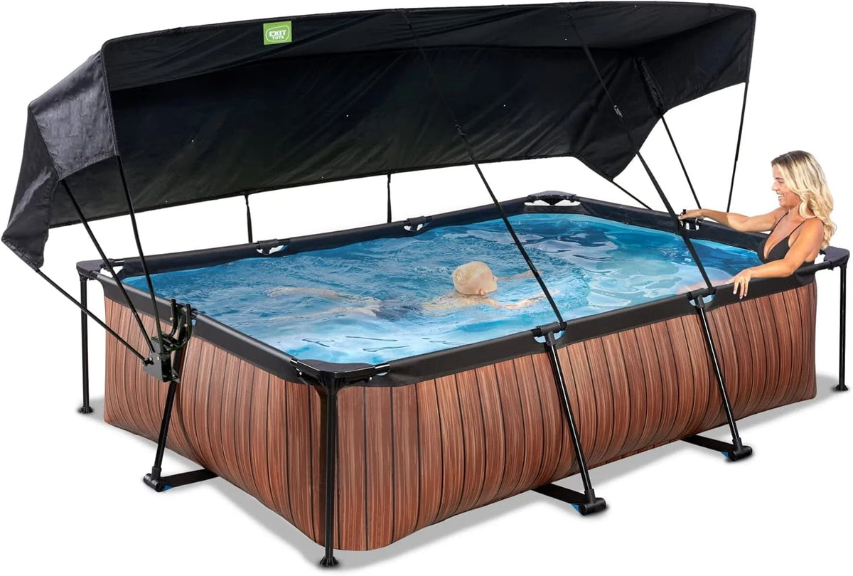 EXIT Toys Piscina de Madeira com Toldo Solar - 300x200x65cm - Piscina de Estrutura Retangular Compacta com Bomba de Filtro de Cartucho - Ótima Proteção UV - Fácil Acesso - Design Exclusivo - Marrom